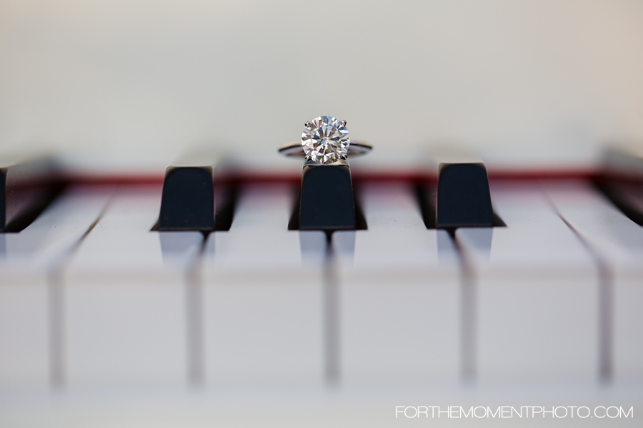 Large diamond engagement ring on baby grand piano